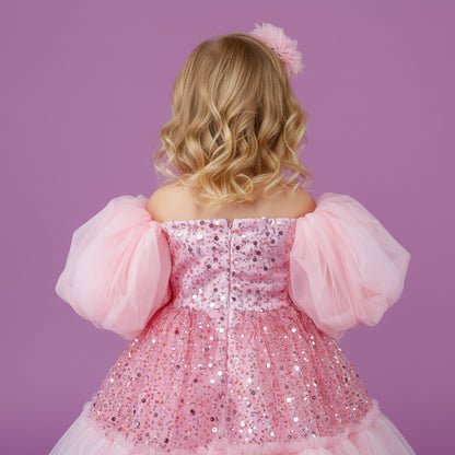 Roze meisjesfeestjurk met opvallende pofmouwen, glinsterende pailletten en zachte tule lagen
